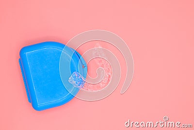 Plastic impression of teeth. Orthodontic silicone trainer. Mobile orthodontic appliance for dental correction, on pink Stock Photo