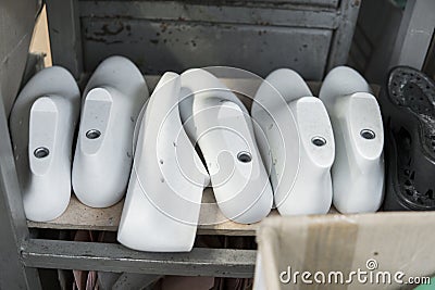 Plastic lasts used in the manufacture of shoes. Row of plastic shoe lasts used to manufacture modern day shoes. A lot of Stock Photo