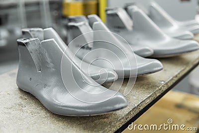Plastic lasts used in the manufacture of shoes. Row of plastic shoe lasts used to manufacture modern day shoes. A lot of Stock Photo
