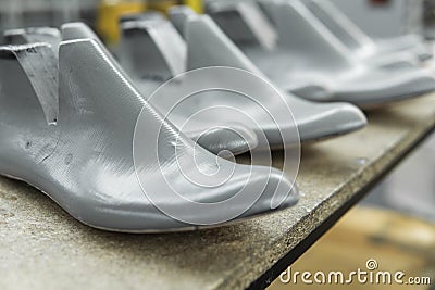 Plastic lasts used in the manufacture of shoes. Row of plastic shoe lasts used to manufacture modern day shoes. A lot of Stock Photo