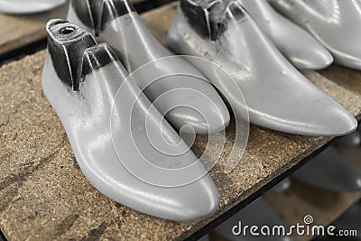 Plastic lasts used in the manufacture of shoes. Row of plastic shoe lasts used to manufacture modern day shoes. A lot of Stock Photo