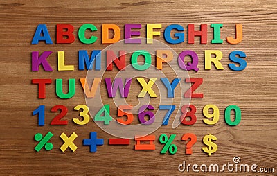 Plastic magnetic letters, numbers and math symbols on wooden background Stock Photo