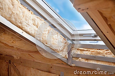 Plastic mansard or skylight window on attic with environmentally friendly and energy efficient thermal insulation rockwool Stock Photo