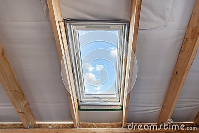 Plastic mansard window with double glasses and clear view on sky Stock Photo