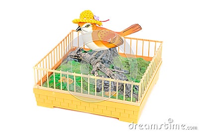Plastic mechanical clockwork singing orange vintage bird on stand isolated on white background Stock Photo