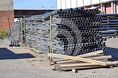 Plastic pipes in stock of finished products stacked in packs Stock Photo