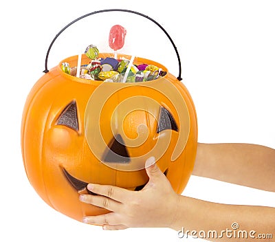 A plastic pumpkin filled with candy Stock Photo