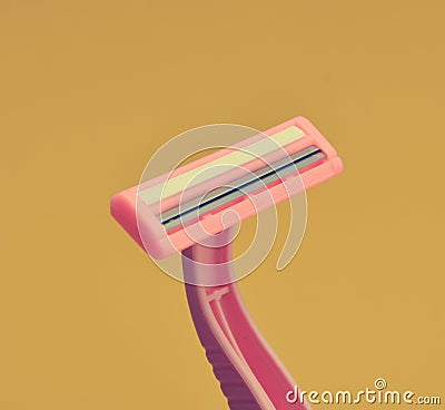 Plastic razor for depilation close-up on a yellow background Stock Photo