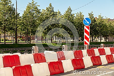 Plastic road fence on the street of the city. red and white water blocks to restrict traffic during road works. Stock Photo