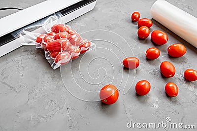 Plastic sealing machine. Vacuum packaging of fresh tomatoes. Flat lay Stock Photo