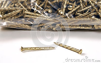 A bag of twisted gold colour nails used for many securing projects-close up Stock Photo