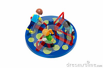 Plastic toy children figures playing in blue park wheel with yellow circles isolated Editorial Stock Photo