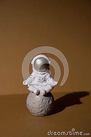 Plastic toy figure astronaut on beige neutral background Copy space. Concept of out of earth travel, private spaceman Stock Photo