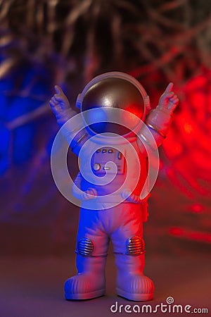 Plastic toy figure astronaut with red and blue light Copy space. Concept of out of earth travel, private spaceman Stock Photo