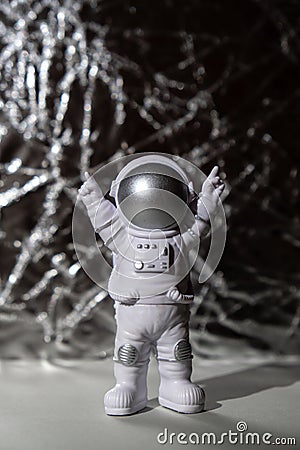 Plastic toy figure astronaut on silver background Copy space. Concept of out of earth travel, private spaceman Stock Photo