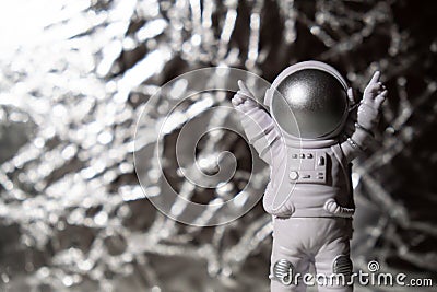 Plastic toy figure astronaut on silver background Copy space. Concept of out of earth travel, private spaceman Stock Photo