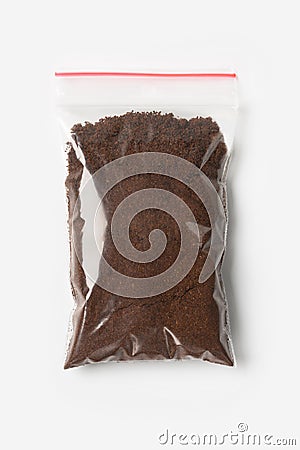 Plastic transparent zipper bag with full Brewed coffee powder isolated on white, Vacuum package mockup with red clip. Concept Stock Photo