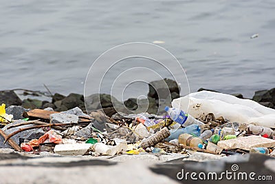 plastic trash garbage on the bay walk polluting the ocean and en Editorial Stock Photo