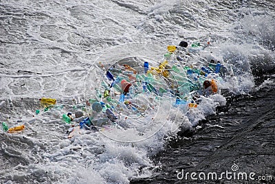 Plastic trash trapped at waterfall Stock Photo