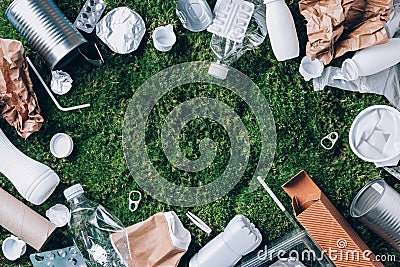 Plastic waste, food packaging, trash collection on green moss background after picnic in forest. Plastic free. Top view Stock Photo