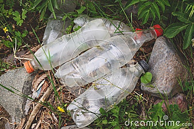 Plastic waste and water bottles, spilled garbage on the grass Stock Photo