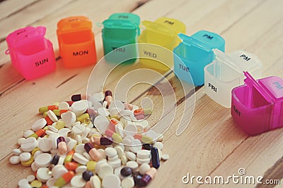 A plastic weekly pill box. Daily pill box with medications and nutritional supplements. Stock Photo