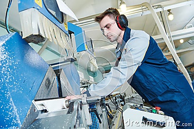 Plastic window and door manufacturing. Worker cutting PVC profile Stock Photo