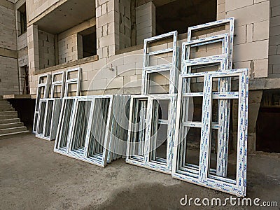 Makhachkala, Dagestan, RUS - December 07, 2019 Prepared for installation plastic windows and doors are folded at the building Editorial Stock Photo