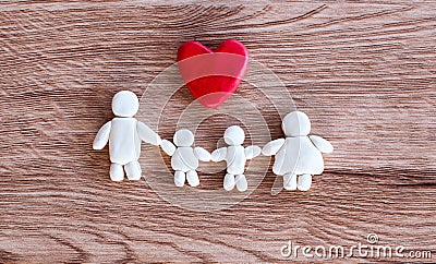Plasticine clay happy family with heart on wooden background Happy family and love concept Stock Photo