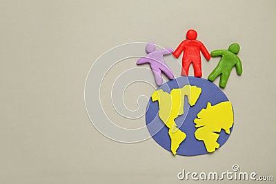 Plasticine figurines of people of different races are on planet earth. A variety of interactions, communication and globalization Stock Photo