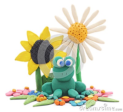 Plasticine frog and flowers. Stock Photo