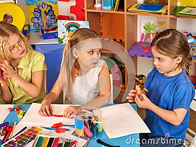 Plasticine modeling clay in children class. Teacher teaches in school. Stock Photo