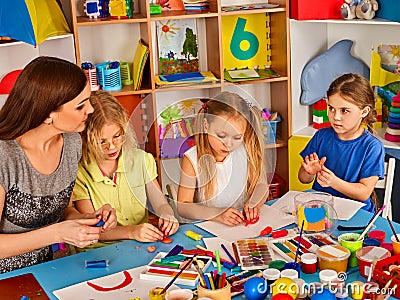 Plasticine modeling clay in children class. Teacher teaches in school. Stock Photo