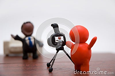 Plasticine photographer with businessman Stock Photo
