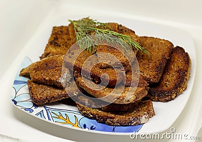 Plate appetizing pieces of black bread with a sprig of dill Stock Photo