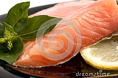 The plate with the appetizing salmon, basil and lemon Stock Photo