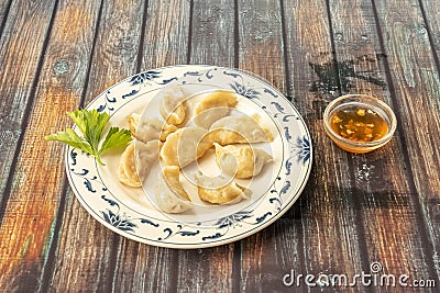Plate of Asian boiled gyoza with sweet and sour sauce Stock Photo