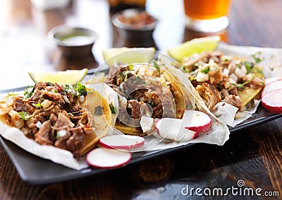 Plate of authentic mexican street style tacos with radish slices Stock Photo