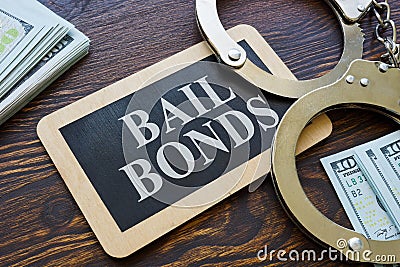Plate Bail bonds and handcuffs on it. Stock Photo