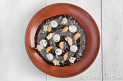 A plate of black squid risotto Stock Photo