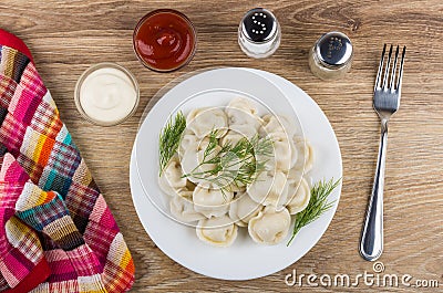 Plate with boiled dumpling, napkin, pepper, salt, mayonnaise, ketchup Stock Photo
