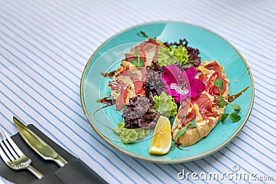 A plate with bruschetta with salmon and curd cheese. Sandwich with smoked salmon Stock Photo