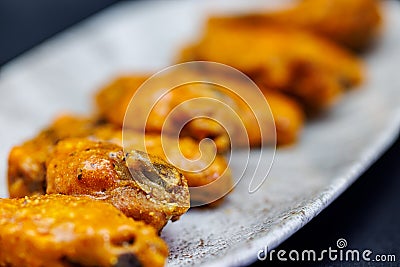 Plate of Buffalo chicken wings on a black background Stock Photo