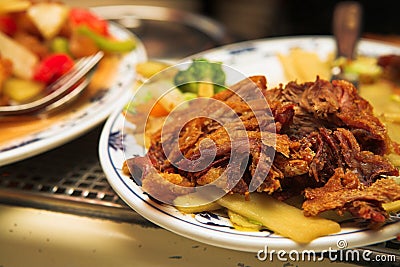 Plate of Chinese fried duck on a burner Stock Photo