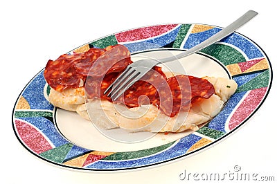 Plate of cod with chorizo close-up on white background Stock Photo