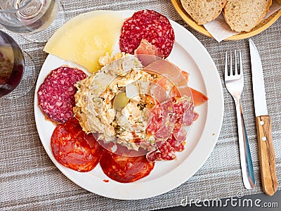 Plate with coldcuts and russain salad, Spanish entremets Stock Photo