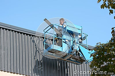 Plate company works with roofing of sheet metal. Editorial Stock Photo