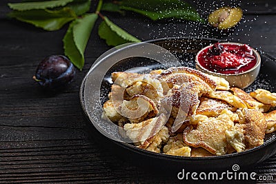 Plate with cutted pancakes and plums Stock Photo