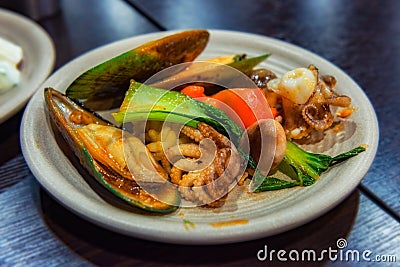 A plate with delicious seafood, NZ mussel and baby octopus for lunch Stock Photo