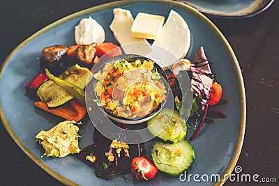 Plate with different food on a wooden table. Top view of the restaurant table with an assortment of meat side dishes Stock Photo